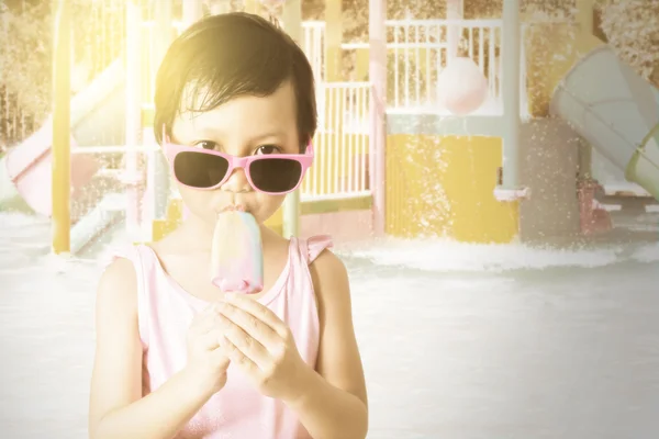 Lovely child enjoy ice cream at pool
