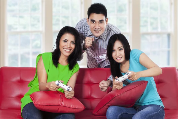 Young people playing games at home