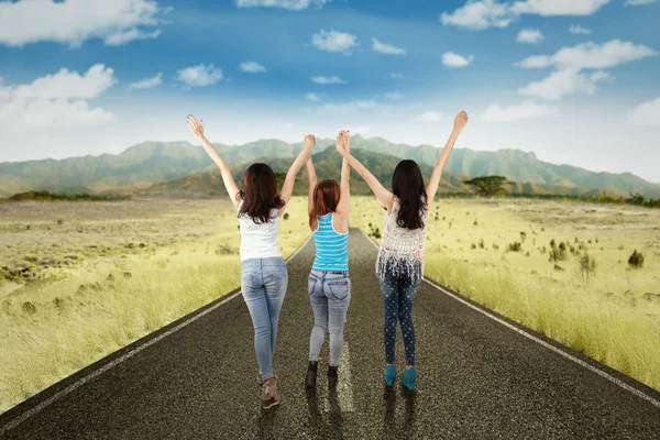 Girls enjoy freedom on the countryside road