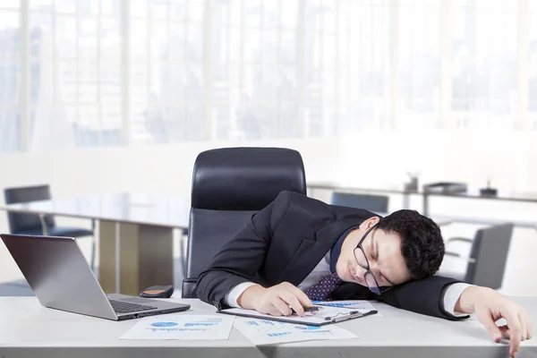 Overworked worker sleeping at workplace