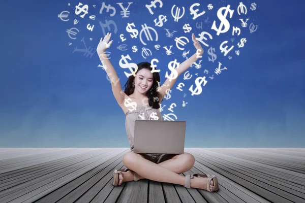 Successful girl making money online with laptop