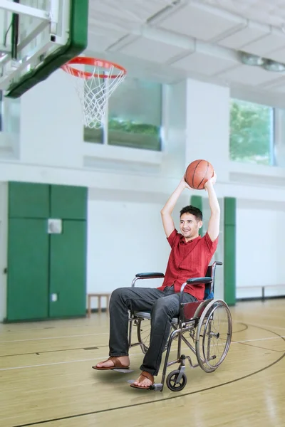 Player throwing ball at the basket