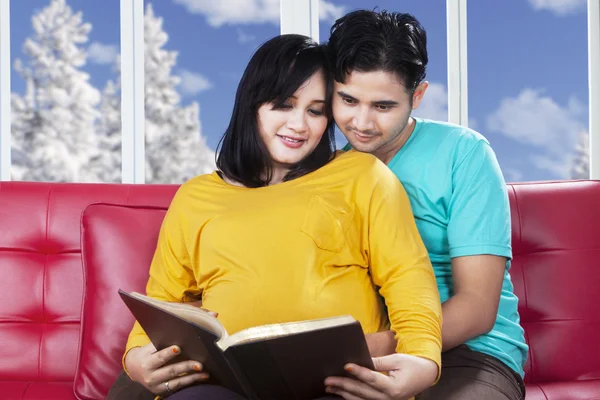Pregnant mother read book with husband