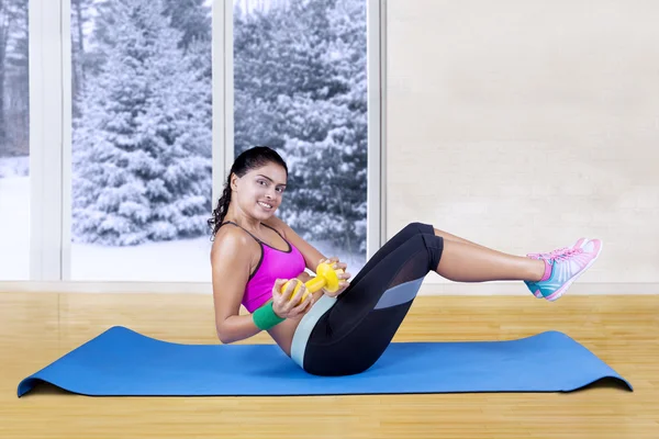 Woman doing workout on mattress at home