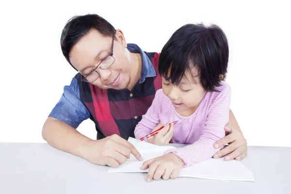 Man helps his child doing homework