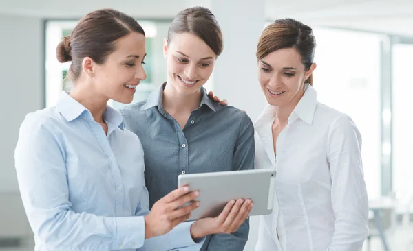 Female business team using a digital tablet