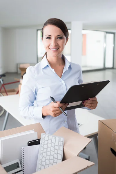 Businesswoman writing a relocation checklist