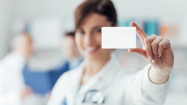 Doctor holding a blank business card