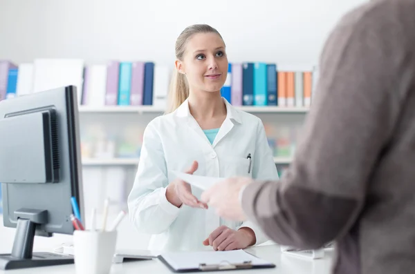 Customer handing a medical prescription