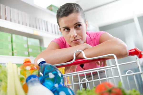 Exhausted woman at supermarket