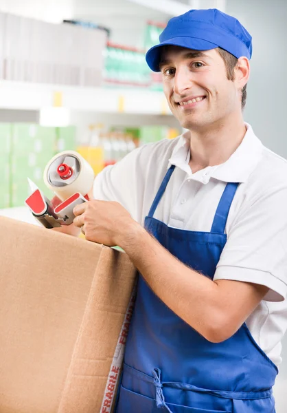 Sales clerk with cardboard box