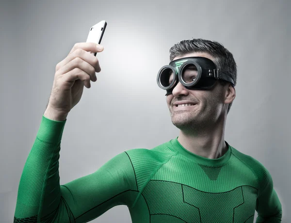 Superhero taking a selfie with a smartphone