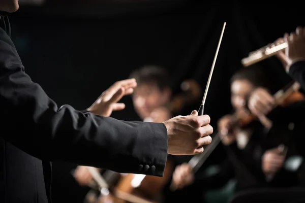 Conductor directing symphony orchestra