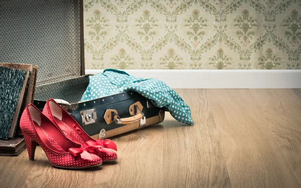 Open vintage suitcase with shoes