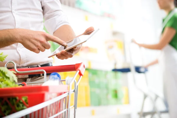 Customer using  tablet at supermarket