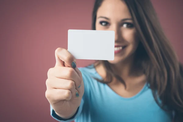 Woman holding blank business card