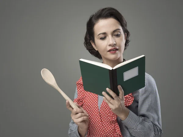 Woman holding an open cookbook