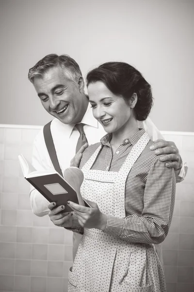 Wife and husband reading a cookbook