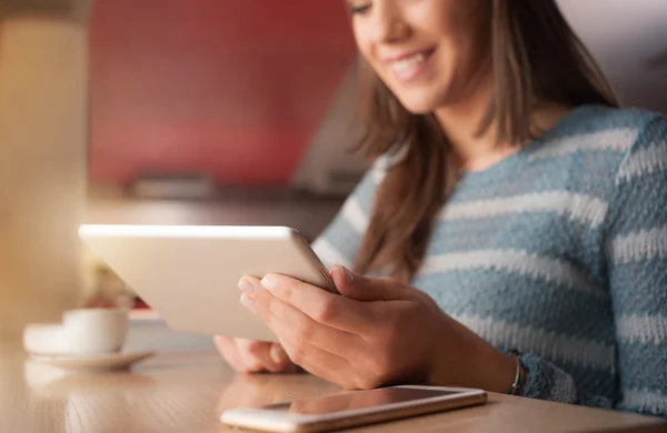 Woman typing on touch screen tablet