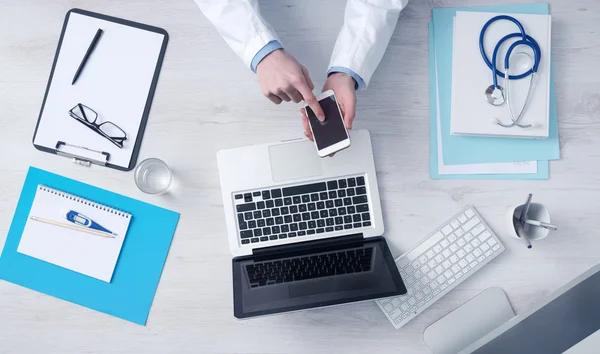 Doctor working at office desk