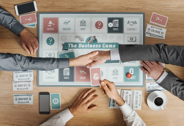 Business people playing a board game