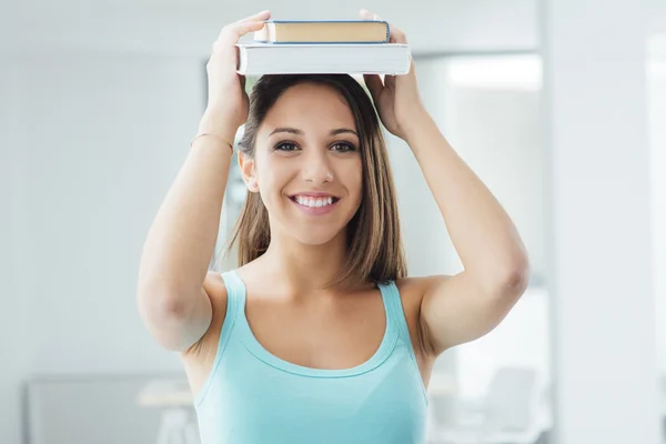 Girl carrying books on her head