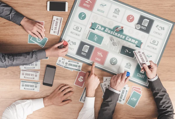 People playing a business board game