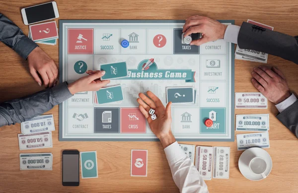 Business people playing a board game