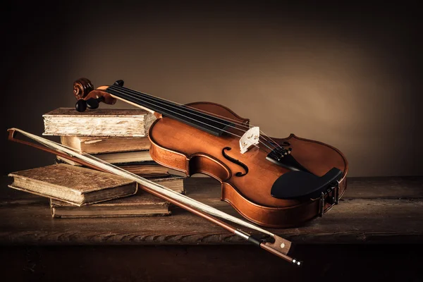 Violin, bow and old books