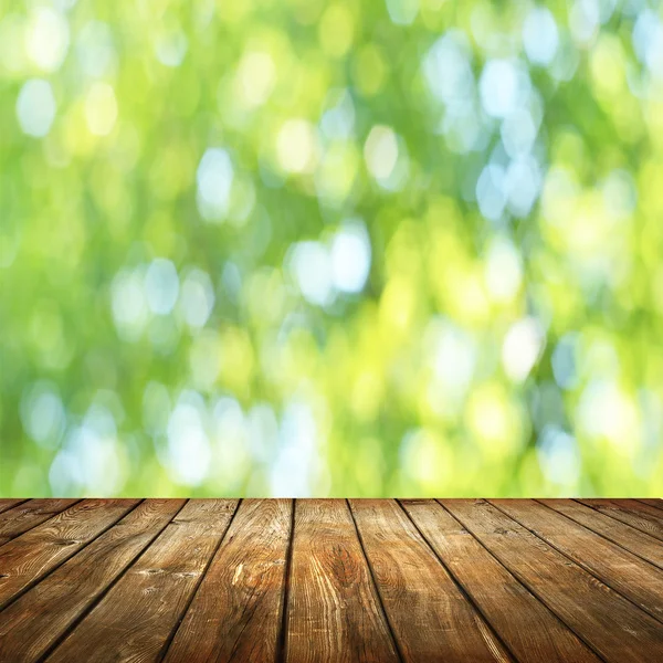 Empty table  with blurred green background