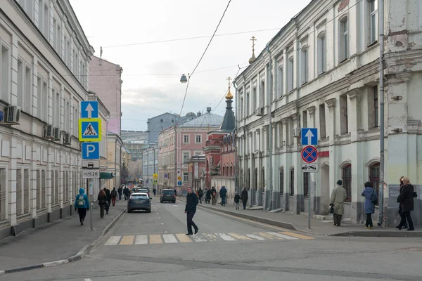 Buildings, people and cars in Podkolokolny street in Moscow