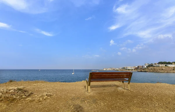 Long bench beside the Mediterranean sea