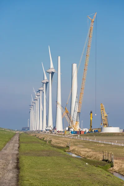 Construction site of new big Dutch wind farm in agricultural landscape