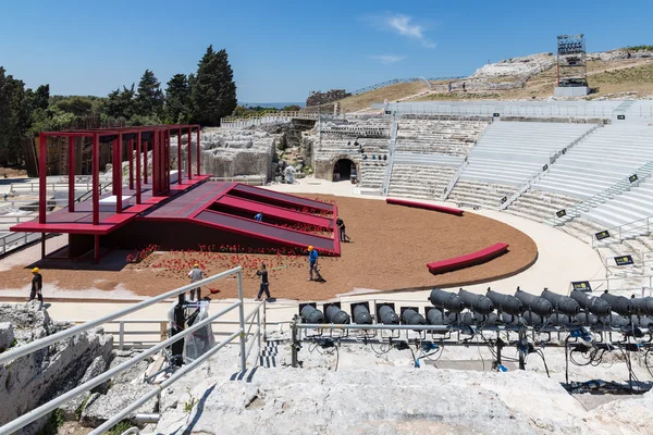 Workers preparing stage in the Greek theatre of Syracusa, Sicily