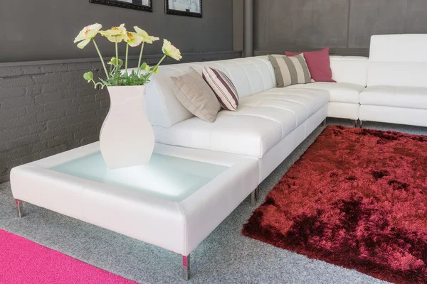 Couch with white upholstery and pillows