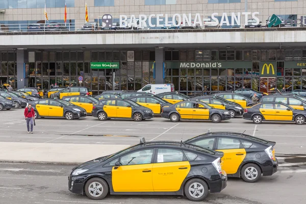 Travelers and taxis waiting in front of the railway station Barcelona-Sants in Barcelona, Spain