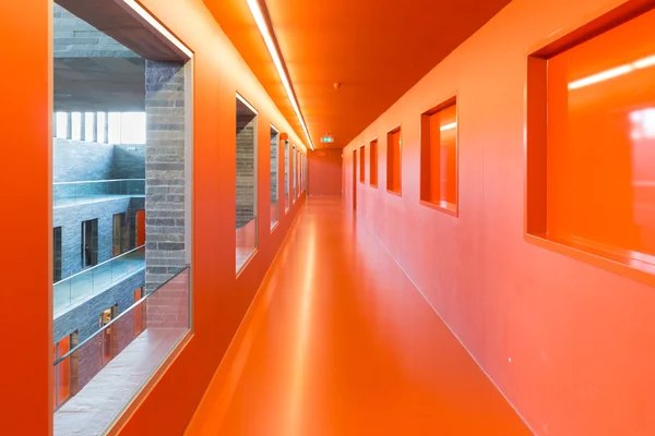 Interior modern building with several floors and orange painted passages