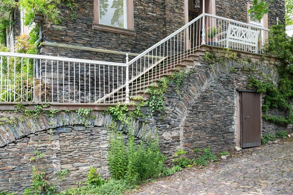 House with brick stone facade and stone stairs