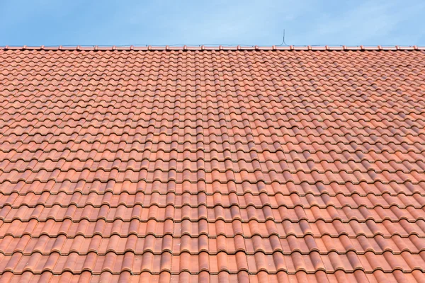 Red tiles roof background and blue sky