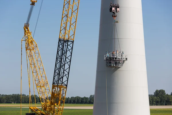 Dutch workers busy with the constuction of a new windturbine