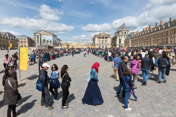 Visitors waiting in long  queues  to visit the Palace of Versailles, Paris, France