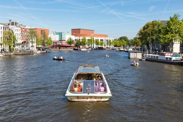 Canal with recreating people in a cruise ship in Amsterdam
