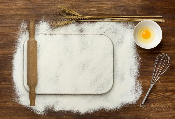 Dough recipe ingredients like eggs, flour on white wooden table