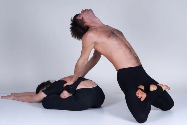 Young healthy couple in yoga position, Man and woman