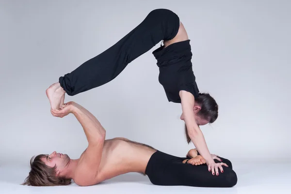 Young healthy couple in yoga position, Man and woman