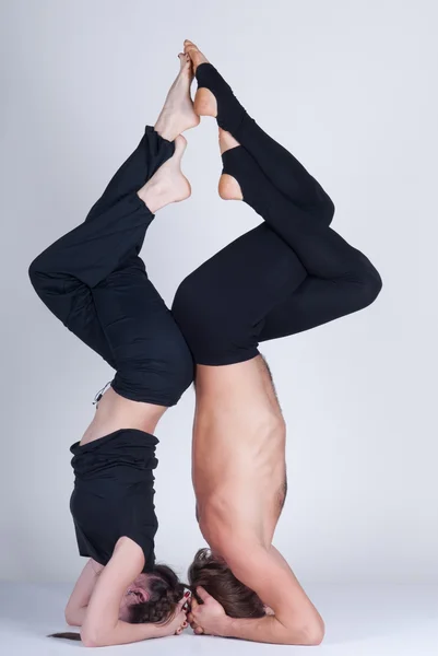 Young healthy couple in yoga position, Man and woman