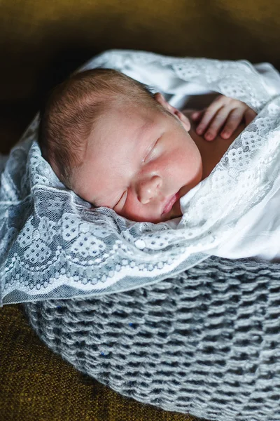 Sleeping newborn baby wrapped in a blanket