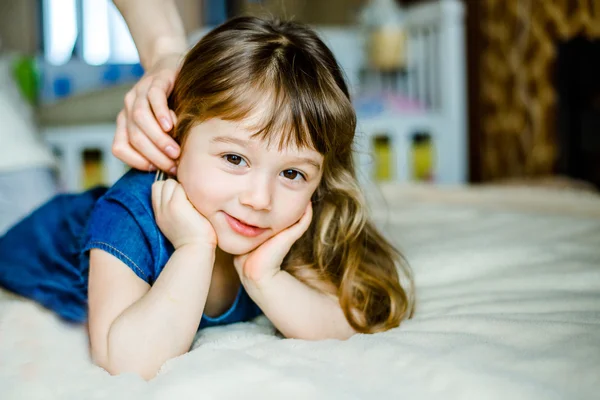 Adorable smiling little girl waked up in her bed