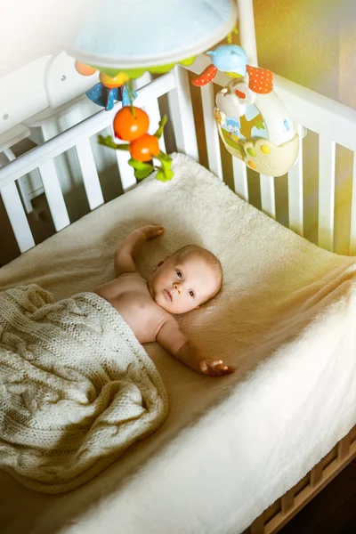 Two month old baby sound asleep in his crib