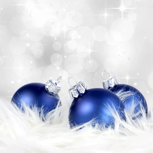 Christmas background with blue silver ornaments on billowy feathers